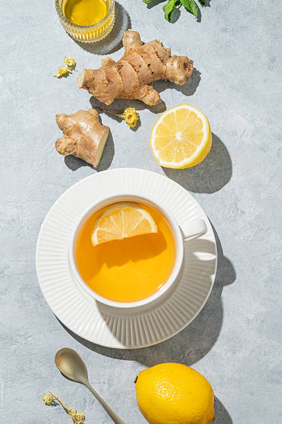 istock Hot tea with lemon, ginger, honey, and mint in a cup on a blue background 2240785344
