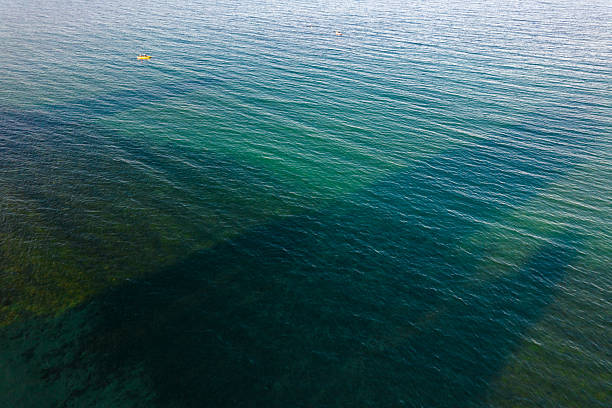 istock Kayak floating on calm clear turquoise sea water 2240785623