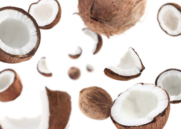 istock Coconuts swirling in air against white background 2240785915