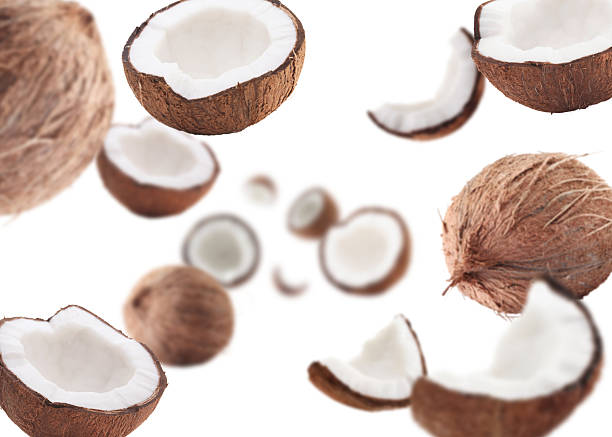 istock Coconuts swirling in air against white background 2240785952