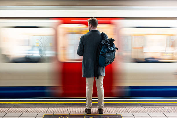 istock Man waiting at subway station as train passes 2240790414