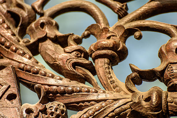 Close-up of a medieval wooden carving depicting a fish, showcasing the detailed craftsmanship and artistic symbolism of the period. The aged wood surface and intricate carving reveal the texture, patina, and spiritual or decorative significance often found in medieval ecclesiastical or architectural art. St Peter & St Paul's Church, Lavenham, Suffolk