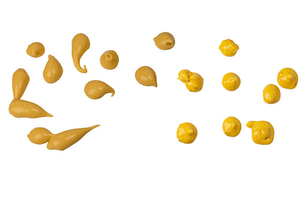 Yellow sauce splashes isolated on white background.  Top view.