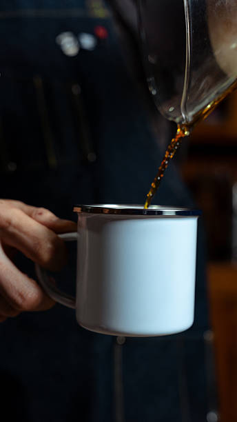 istock Barista pouring fresh brewed coffee into enamel mug 2240794378