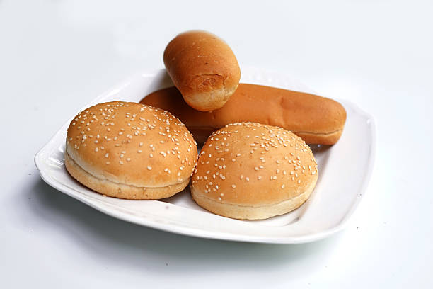 istock Soft hamburger bun and hot dog rolls on white plate. 2240794893