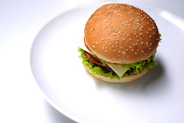 Hamburger with lettuce and tomato on white background.