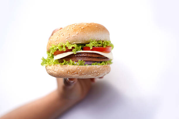 Cheeseburger on hand. food photography.