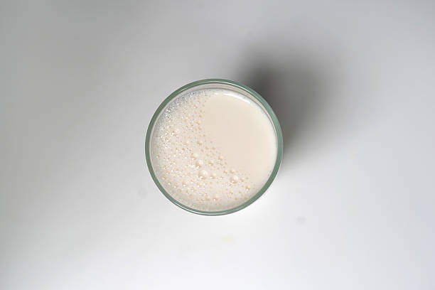 istock Fresh Morning Milk in Clear Glass on White Table. top view. 2240796268
