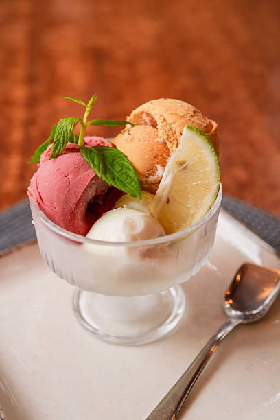 Trio of Ice Cream Scoops with Lemon and Mint Garnish