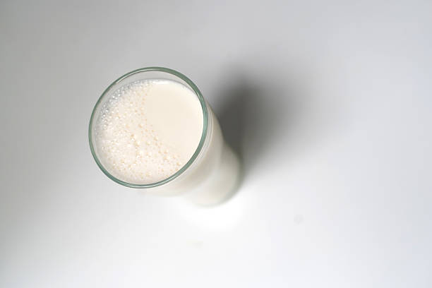 istock Full Glass of Milk on Clean White Surface. 2240796633