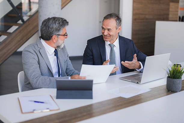 istock Businessmen discussing financial plans during office meeting 2240796668