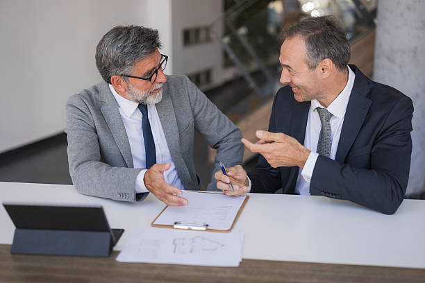 istock Two businessmen discussing contract signing in office meeting 2240796738