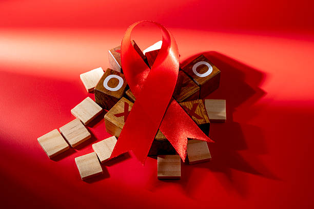 Red ribbon on a red background. Symbolizing awareness and support for HIV or AIDS patients. World Aids Day. Concept of Healthcare and Medicine