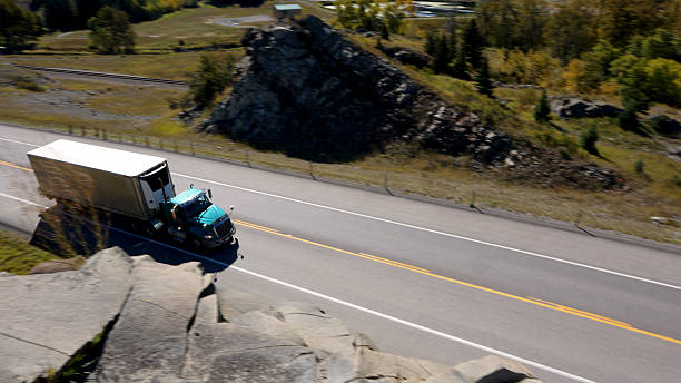 Elevated view of freight truck on mountain highway in autumn, Crowsnest Pass, Canadian Rockies