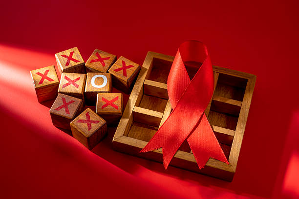 Red ribbon on a red background. Symbolizing awareness and support for HIV or AIDS patients. World Aids Day. Concept of Healthcare and Medicine