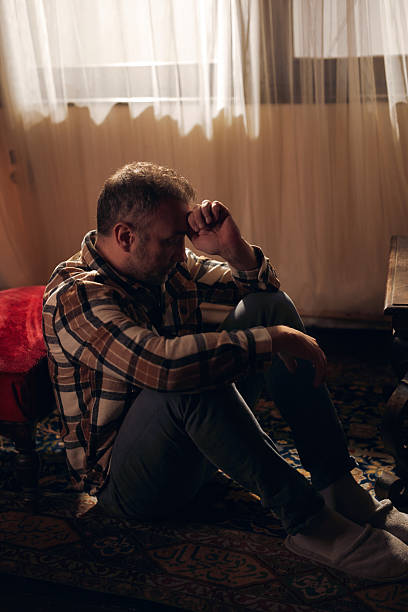 istock Man with depression and headache at home. 2240798977