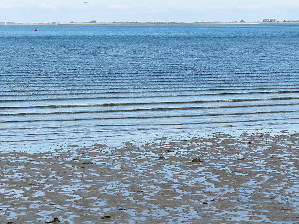 View over the rippled water of the Eastern Scheldt at low tide in Wemeldinge,  a village located in the province of Zeeland in the Netherlands.