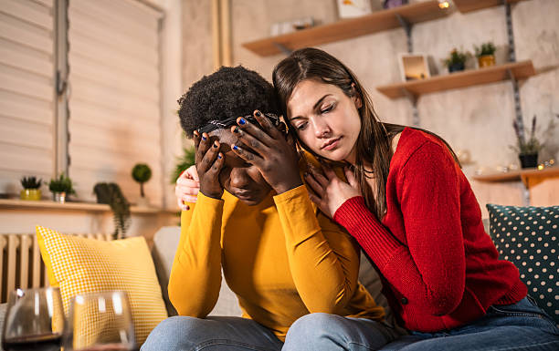 istock Woman comforting sad friend feeling stressed at home 2240799092