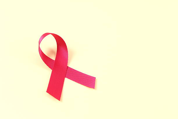 istock Aids awareness red ribbon on yellow background 2240804325