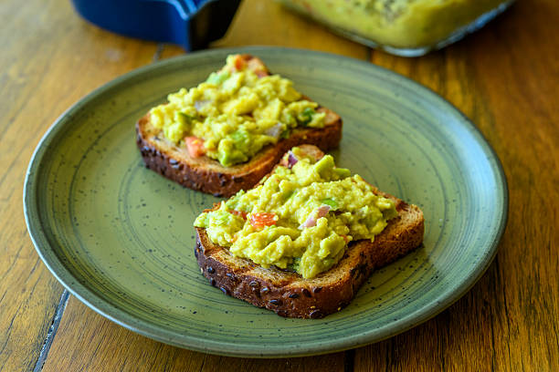 istock Guacamole Avocado Toast with Fresh Vegetables on Whole Grain Bread 2240804545