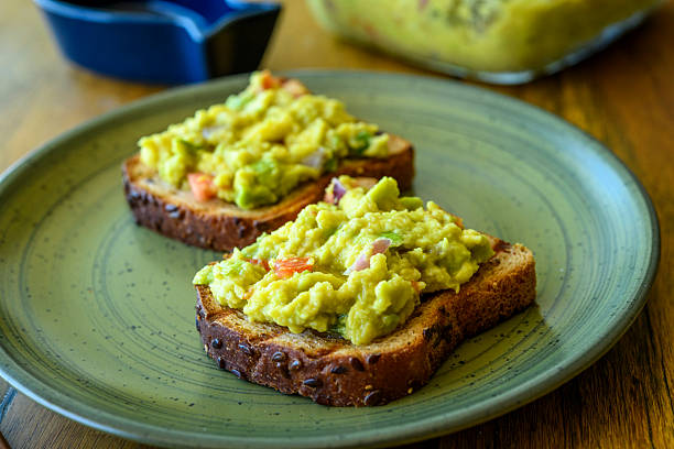 istock Guacamole Avocado Toast with Fresh Vegetables on Whole Grain Bread 2240804546