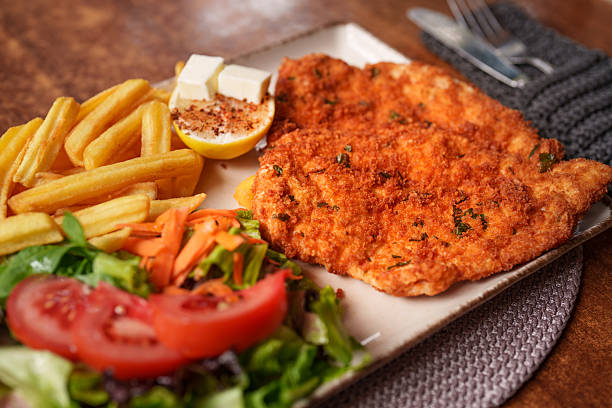 istock Crispy Chicken Schnitzel with Fries and Salad 2240807908