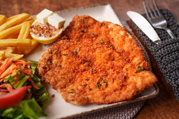 istock Crispy Chicken Schnitzel with Fries and Salad 2240808289