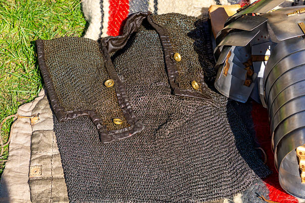istock Chainmail armor made of metal rings with leather edging and brass buttons, medieval protective gear used during historical reenactments and demonstrations of ancient combat techniques 2240809616