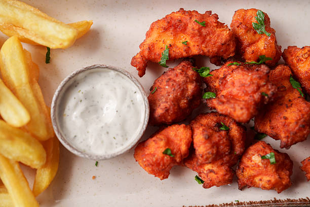 Spicy buffalo chicken bites coated in tangy hot sauce, served alongside crispy fries and cool ranch dressing. A bold and flavorful snack that perfectly balances heat and creaminess.