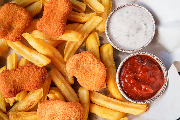 Crispy golden chicken nuggets served over a bed of fries, paired with two classic dips — tangy ketchup and creamy ranch sauce. A comforting and satisfying fast-food favorite.