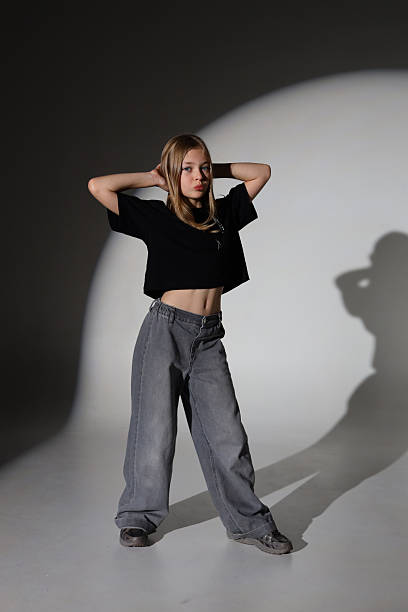 istock Young caucasian female posing in studio with shadows and contrast lighting 2240812412