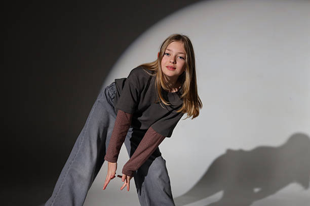 istock Caucasian young female stretching in studio with dramatic lighting 2240812683