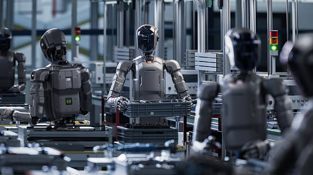 istock 3D Render: Industrial AI Transformation: Autonomous AI Powered Humanoid Robot Walking through a Factory and Transporting a Box with Details. Advanced Human Like Robot Working in Industrial Environment 2240813695