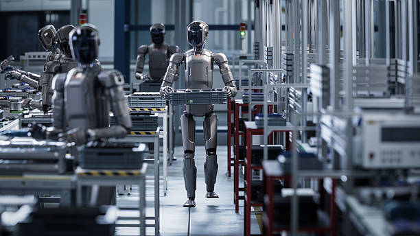 istock 3D Render: Industrial AI Transformation: Autonomous AI Powered Humanoid Robot Walking through a Factory and Transporting a Box. Advanced Human Like Robot Working in Industrial Environment. 2240813697