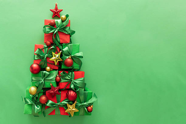 istock Christmas Tree Made of Gift Boxes with Ornaments on Green Background 2240817785