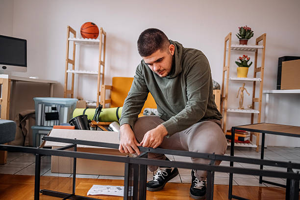 istock Young people assembling bookshelf in their new home 2240824935