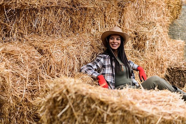 istock Serene Female Farmer on Hay Bale 2240825609