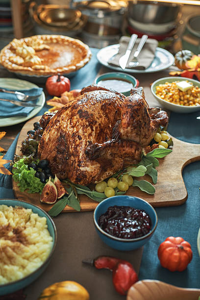 istock Having Stuffed Turkey for Thanksgiving Holiday Dinner with Vegetables and Gravy 2240833427
