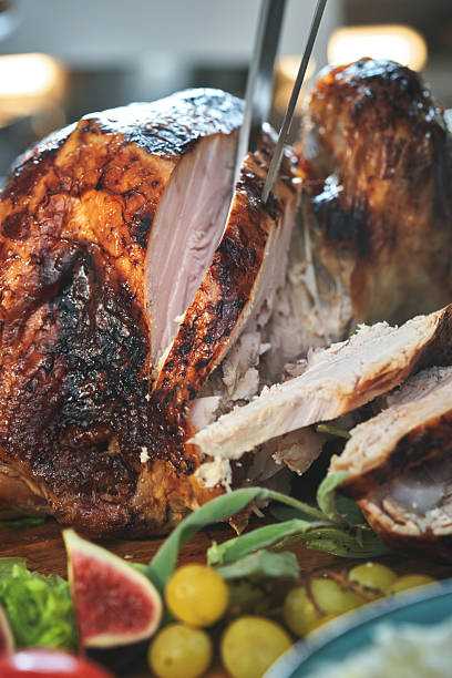 Having Stuffed Turkey for Thanksgiving Holiday Dinner with Vegetables and Gravy