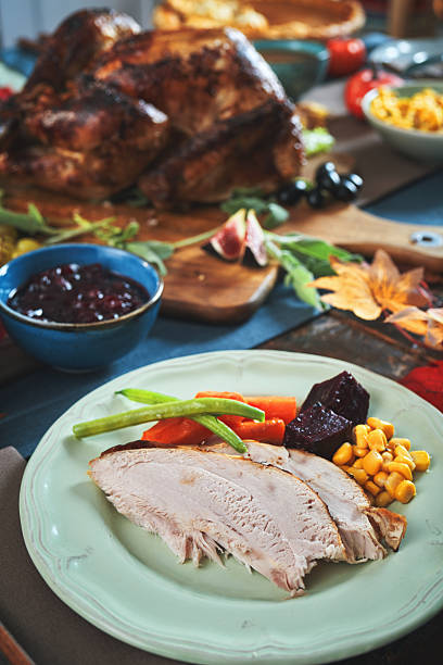 istock Having Stuffed Turkey for Thanksgiving Holiday Dinner with Vegetables and Gravy 2240833651