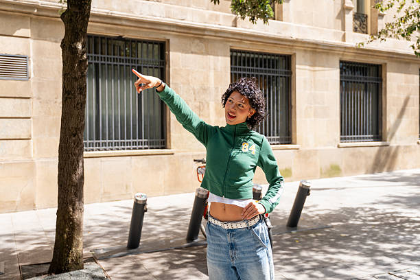 istock Young woman pointing finger in urban setting 2240834900