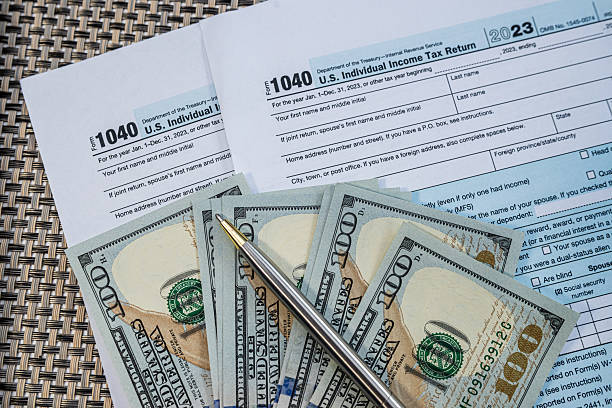 istock U.S. tax return documents with pen and dollar bills on table during financial filing process 2240837751