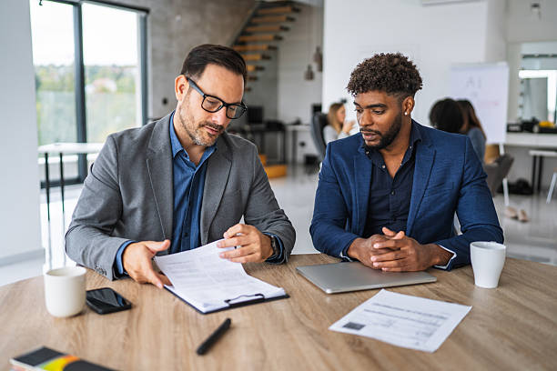 istock Businessmen discussing contract terms during an office meeting 2240840935