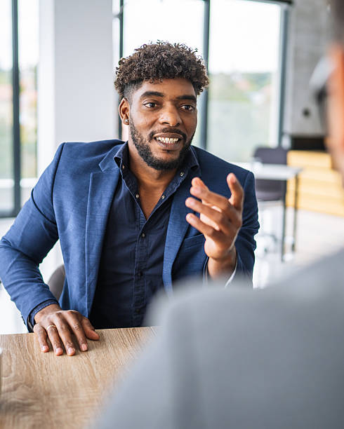 istock Young black man discussing during business meeting in modern office 2240840976