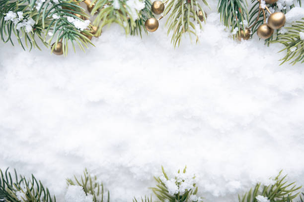 istock Christmas tree branches on snow with golden decorations 2240842251