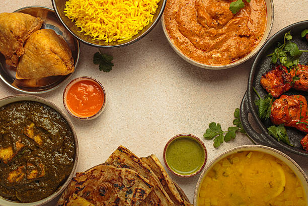 istock Traditional assorted Indian dishes arranged top view on beige background table. Cuisine of India, space for text 2240843553