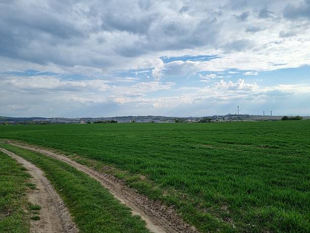 istock Farmland with Distant Town and Sky 2240844267