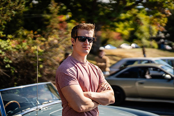 istock Man Standing by Muscle Car at Meetup 2240846459