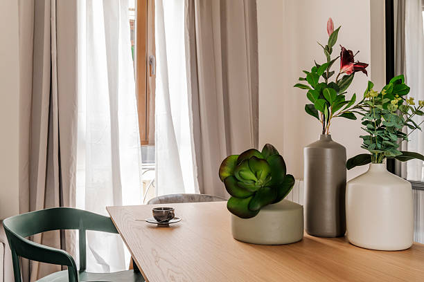 istock porcelain vases with decorative plants and a cup of coffee on a rectangular wooden table and a window with curtains and net curtains 2240846623