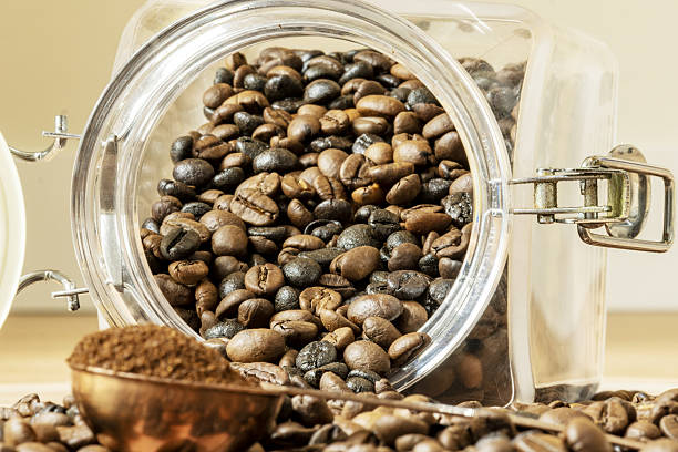 istock Overturned coffee beans from a tin and a copper meter with ground coffee 2240846641
